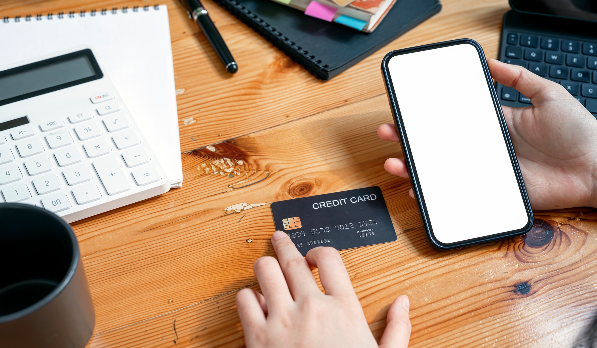 Woman holding smartphone and credit card. online banking, transfer money. cropped image